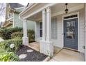 Welcoming front porch featuring stately columns, stylish shutters, and a solid front door at 264 Ascott Ln, Woodstock, GA 30189