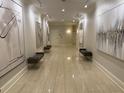 Hallway with neutral-toned walls, tiled floors, recessed lighting, and seating areas along the walls at 3280 Stillhouse Se Ln # 101, Atlanta, GA 30339
