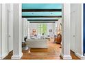 Open-concept living room showcasing hardwood floors, beamed ceilings, and white columns at 4705 Paran Nw Vly, Atlanta, GA 30327