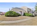 Inviting two-story home with lush landscaping, a well-maintained lawn, and a welcoming entrance at 9390 Knollcrest, Alpharetta, GA 30022