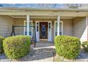 Inviting front porch with a swing, decorative door, and attractive landscaping at 2630 Amber Creek Dr, Douglasville, GA 30135
