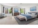 Spacious bedroom with calm decor, large windows, and a cozy seating area by the windows at 5330 Willow Park Blvd, Atlanta, GA 30349