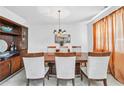 Elegant dining room with a spacious table, comfortable chairs, and a decorative display cabinet at 5330 Willow Park Blvd, Atlanta, GA 30349