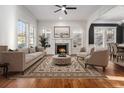 Bright living room with hardwood floors, fireplace, and large windows filling the space with natural light at 970 Welch Sw St, Atlanta, GA 30310