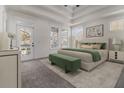 Spacious main bedroom with tray ceiling, soft carpet, and bright natural light at 970 Welch Sw St, Atlanta, GA 30310
