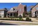 Lovely brick home with manicured lawn, trimmed shrubbery and covered front porch at 184 Cadence Trl, Canton, GA 30115