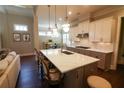 Gourmet kitchen features a large island with seating, quartz countertops and stainless steel appliances at 184 Cadence Trl, Canton, GA 30115