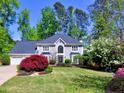 Beautiful home with manicured lawn, mature landscaping, and a classic facade, offering a serene and inviting atmosphere at 3304 Woolbridge Ct, Marietta, GA 30062