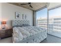 Comfortable bedroom with large window and exposed ceiling at 400 W Peachtree Nw St # 3412, Atlanta, GA 30308