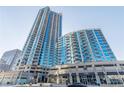 Modern high-rise condo building exterior with striking architecture and retail spaces below at 400 W Peachtree Nw St # 3412, Atlanta, GA 30308