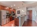 Modern kitchen with stainless steel appliances, granite countertops, and rich wood cabinets at 400 W Peachtree Nw St # 3412, Atlanta, GA 30308
