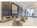 Elegant building lobby with a linear fireplace, comfortable seating, modern art, and marble flooring at 400 W Peachtree Nw St # 3412, Atlanta, GA 30308
