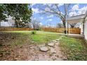 Spacious, fenced backyard with a stone pathway, patio and lush lawn at 996 Moreland Se Ave, Atlanta, GA 30316