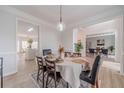 Elegant dining room with wainscoting, hardwood floors, and a view of the kitchen at 1351 Mckendree Park Ct, Lawrenceville, GA 30043