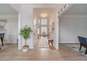 Inviting foyer with hardwood floors, crown molding, and views into adjacent dining and living spaces at 1351 Mckendree Park Ct, Lawrenceville, GA 30043
