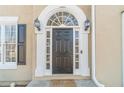 Elegant front entrance with arched transom, sidelights, and a welcoming 'Welcome' mat at 1351 Mckendree Park Ct, Lawrenceville, GA 30043