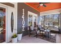 Inviting front porch with comfortable seating and orange-painted ceiling at 1402 Belmont Sw Ave, Atlanta, GA 30310
