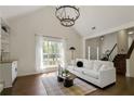Bright and airy living room features a fireplace, a large window, and dark hardwood floors at 5570 Rolling Oaks Dr, Cumming, GA 30040