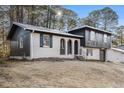 Charming home with brick, wood and black trim nestled on a serene, wooded lot at 6615 Buckhurst Trl, Atlanta, GA 30349