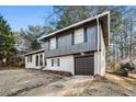 Beautiful home with attached garage with brick and wood features at 6615 Buckhurst Trl, Atlanta, GA 30349