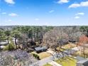 Bird's-eye view of a home nestled among tall trees and blue skies at 8329 Marlborough Dr, Jonesboro, GA 30238