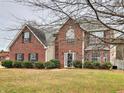 Traditional brick home with a well-kept lawn and mature trees, creating a welcoming curb appeal at 4871 Ship Jack Ln, Decatur, GA 30035