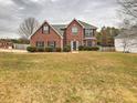 Attractive brick home with a spacious front yard, showcasing a blend of classic design and curb appeal at 4871 Ship Jack Ln, Decatur, GA 30035