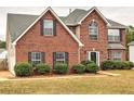 A well-maintained two-story home with brick facade, complemented by lush greenery in the front yard at 4871 Ship Jack Ln, Decatur, GA 30035