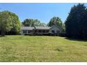 Charming single-story home with a well-maintained lawn and a covered porch, surrounded by lush greenery at 6365 Mountain View Trl, Cumming, GA 30041