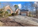 Beautiful brick home with an attached garage and a concrete driveway at 8424 Fairway Dr, Covington, GA 30014