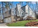 Charming gray home featuring a stone foundation, multiple windows, and a two-car garage at 2421 Spring Lake Dr, Marietta, GA 30062