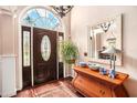 Elegant home foyer with hardwood floors, decorative mirror and lovely front door at 97 Old Burnt Hickory Rd, Acworth, GA 30101