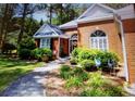 Attractive brick house with well-maintained front yard landscaping and mature bushes at 97 Old Burnt Hickory Rd, Acworth, GA 30101