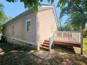 Exterior view of the house with a wooden deck and stairs leading down to the yard at 1059 Sims Sw St, Atlanta, GA 30310