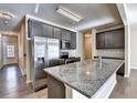 Modern kitchen with stainless steel appliances, granite countertops, and ample cabinet space at 3082 Cedar Glade Ne Ln, Buford, GA 30519