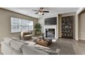 Cozy living room features a fireplace, modern decor, neutral colors, and a large window at 3082 Cedar Glade Ne Ln, Buford, GA 30519