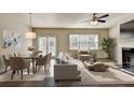 Bright, open-concept living and dining room featuring a fireplace and modern furnishings at 3082 Cedar Glade Ne Ln, Buford, GA 30519