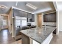 Modern kitchen with granite countertops, stainless steel appliances, and dark wood cabinets at 3802 Cedar Glade Ne Ln, Buford, GA 30519