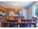 Eat-in kitchen with stainless steel appliances, wooden cabinets, and a large dining table at 1743 Wee Kirk Se Rd, Atlanta, GA 30316