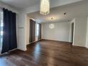 Open living space with hardwood floors, stylish lighting, and lots of natural light at 3794 Allegretto Cir, Atlanta, GA 30339