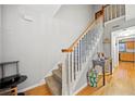 Inviting entryway with wood floors, staircase, and a glimpse of the kitchen at 6520 Roswell Rd # 74, Atlanta, GA 30328