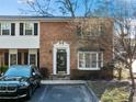 Two-story brick townhouse with a decorative front door, bay window, and a black SUV parked in front at 6520 Roswell Rd # 74, Atlanta, GA 30328