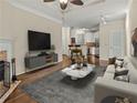 Spacious living room leading to kitchen featuring fireplace, gray sofa, and marble coffee table at 10 Perimeter Summit Ne Blvd # 2405, Atlanta, GA 30319