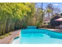 Inviting backyard pool surrounded by lush greenery provides a private oasis at 3261 Turtle Lake Se Ct, Marietta, GA 30067
