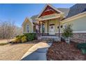 Close up of a well landscaped entryway and porch with tasteful decorations enhancing the home's curb appeal at 100 Walnut Ridge Ct, Covington, GA 30014