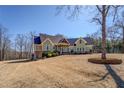 Inviting exterior with well-manicured landscaping, decorative stonework, and charming architectural details with an attached two-car garage at 100 Walnut Ridge Ct, Covington, GA 30014