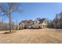 Beautiful exterior elevation of home with a meticulously maintained lawn, complemented by lush greenery and a welcoming two-car garage at 100 Walnut Ridge Ct, Covington, GA 30014