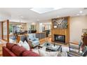 Open-concept living room with stone fireplace and hardwood floors leading to dining area at 1959 Grand Prix Ne Dr, Atlanta, GA 30345