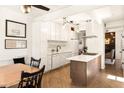 Stylish kitchen features white cabinets, an island, and a breakfast nook area at 651 Park Village Ne Dr, Atlanta, GA 30306