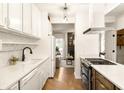 Bright kitchen features white cabinets, quartz countertops, and stainless steel appliances at 651 Park Village Ne Dr, Atlanta, GA 30306